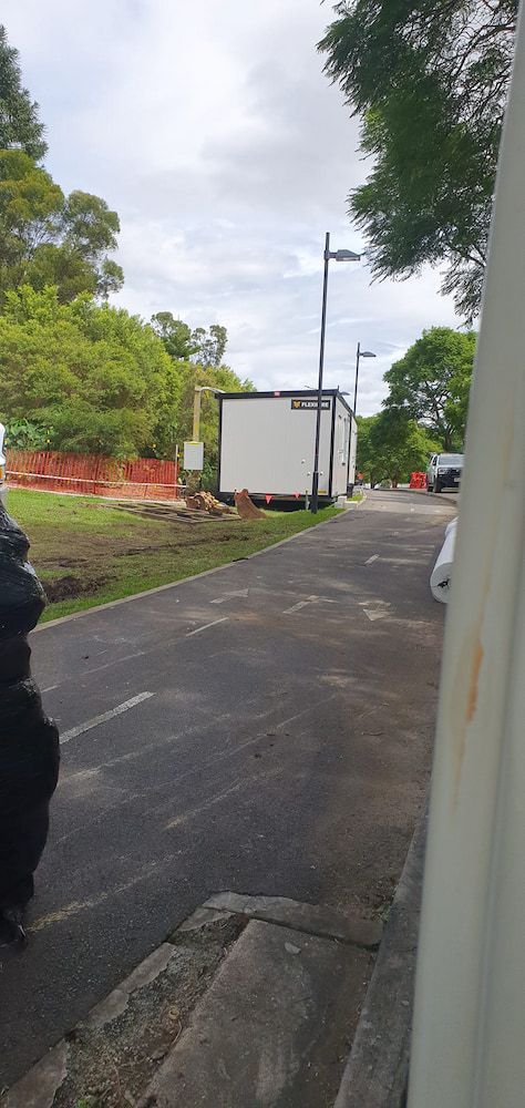 A White Trailer is Parked on the Side of the Road — D.J. Whatley & Son Pty Ltd in Logan, QLD