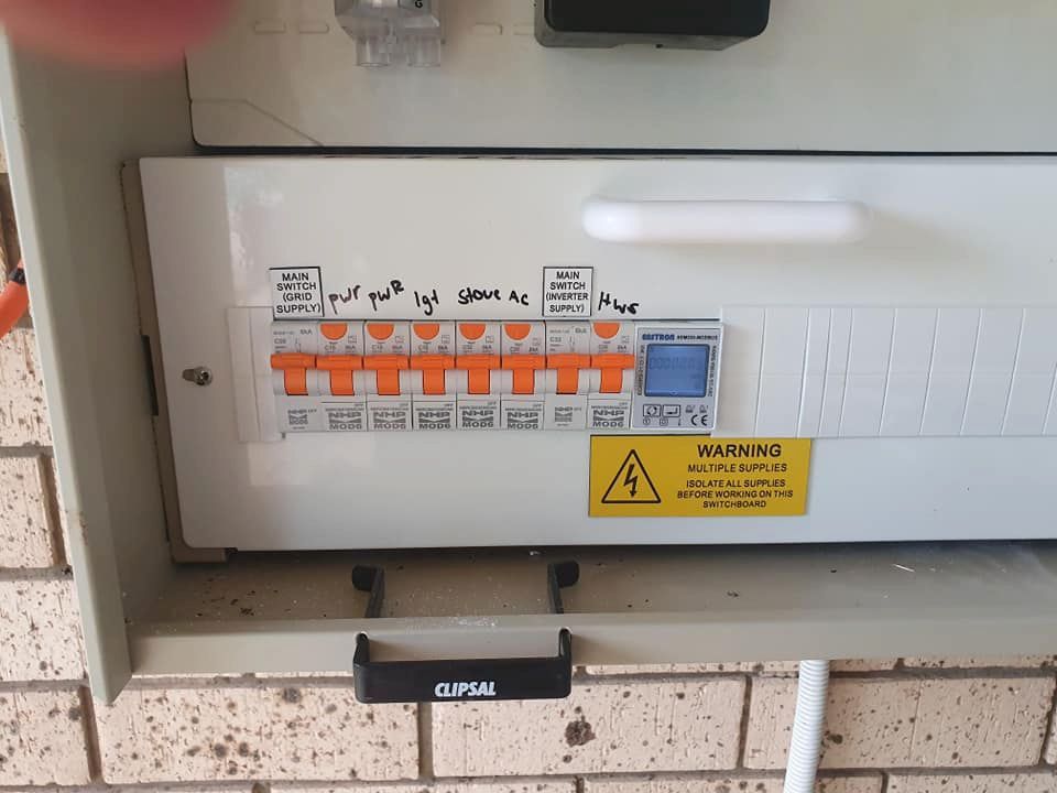 A white box with a yellow warning sign on it — D.J. Whatley & Son Pty Ltd in Ormeau Hills, QLD