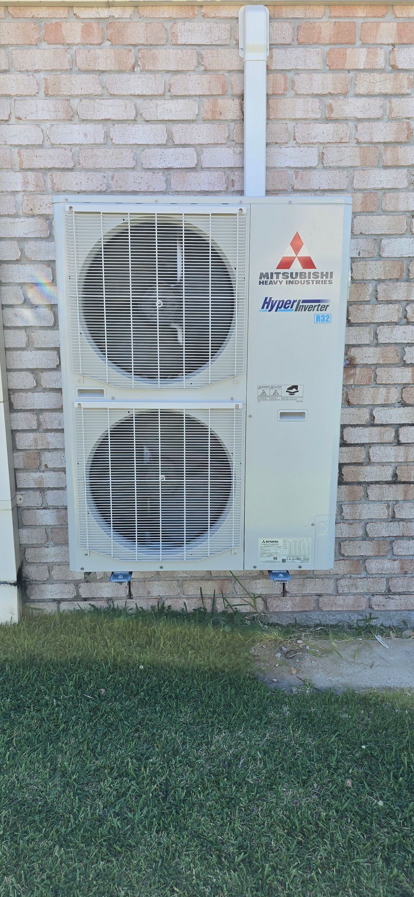 Mitsubishi Air Conditioner is Sitting on a Wooden Deck — D.J. Whatley & Son Pty Ltd in Ormeau Hills, QLD