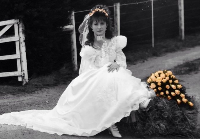 Bride sitting on a rock with a bouquet