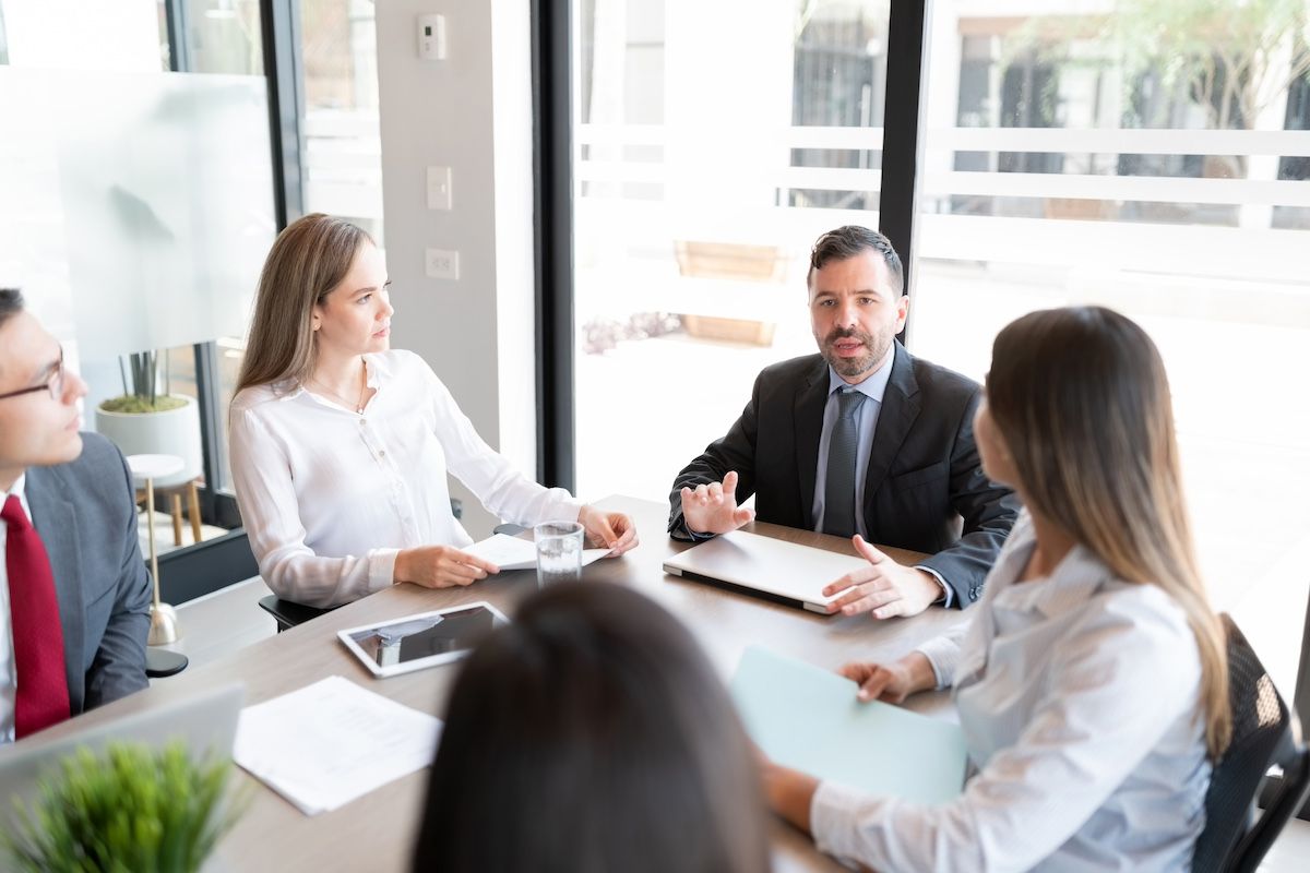 Lawyers, their clients, and a mediator meet to discuss settlement in a Missouri personal injury case