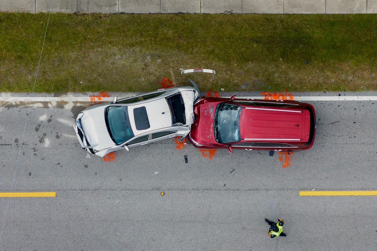 A White & Red Car Photographed From Above After a Car Accident Took Place in Missouri.