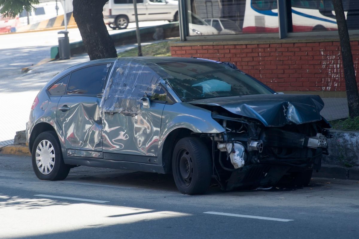 A Gray Car on the Side of the Road After an Accident. Call the MO Car Crash Lawyer at Duckworth Inju