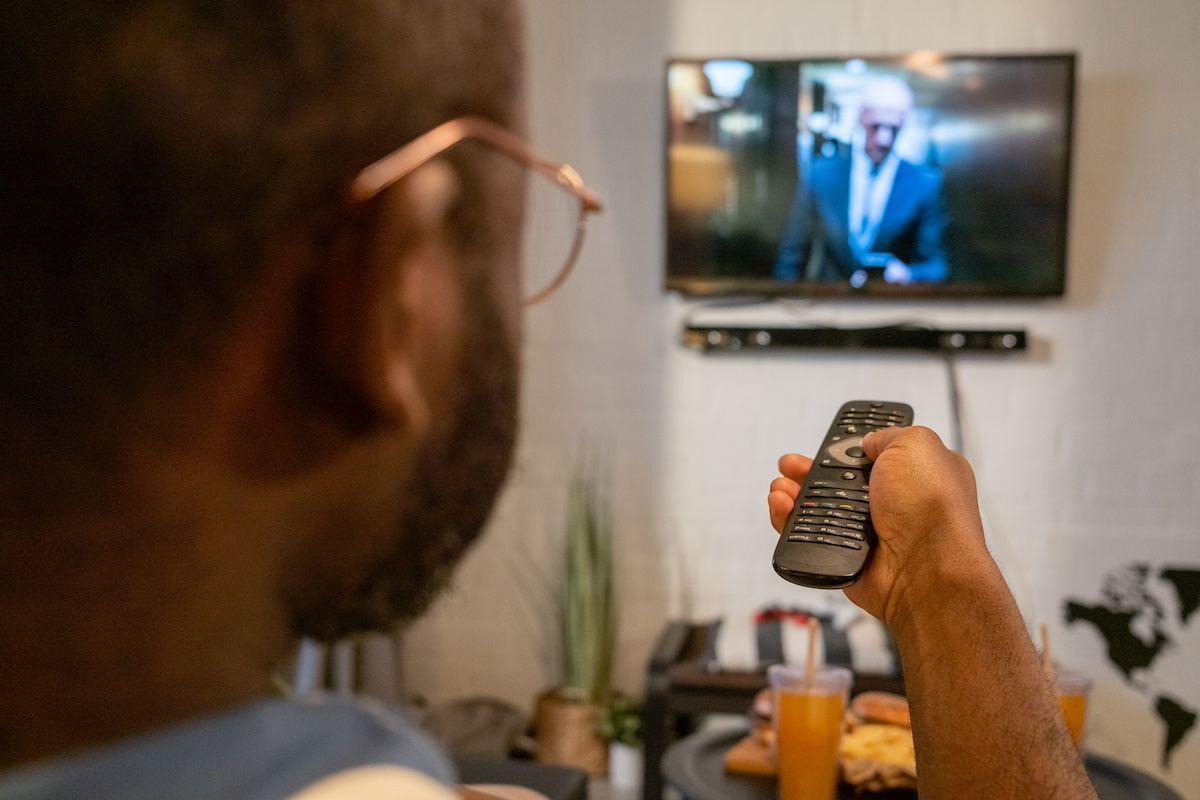 A Man Watches A Law Firm Commercial On TV. Call Duckworth Injury Law For A Free Consultation. 