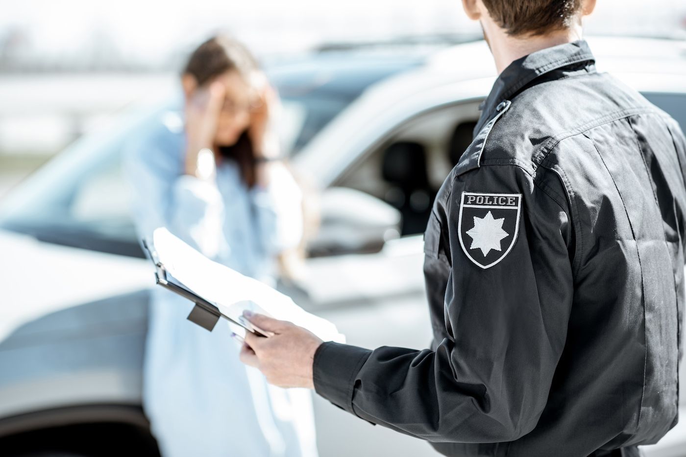 A police officer takes a crash report statement from a car accident victim in Columbia, MO.
