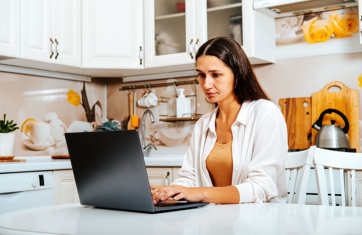 A Woman Sits in Front of a Computer. Research Personal Injury Attorneys Before Hiring in Mid-MO.