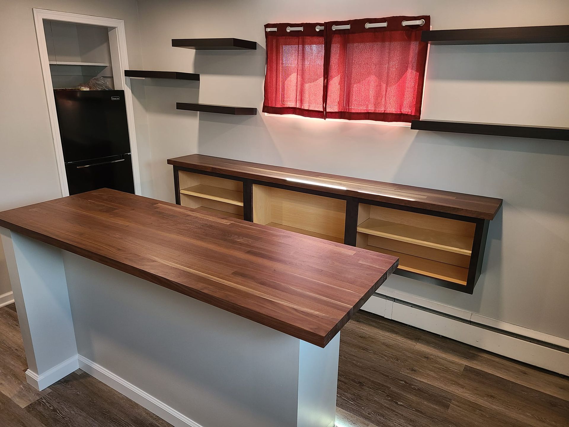 a kitchen with a wooden counter top and shelves