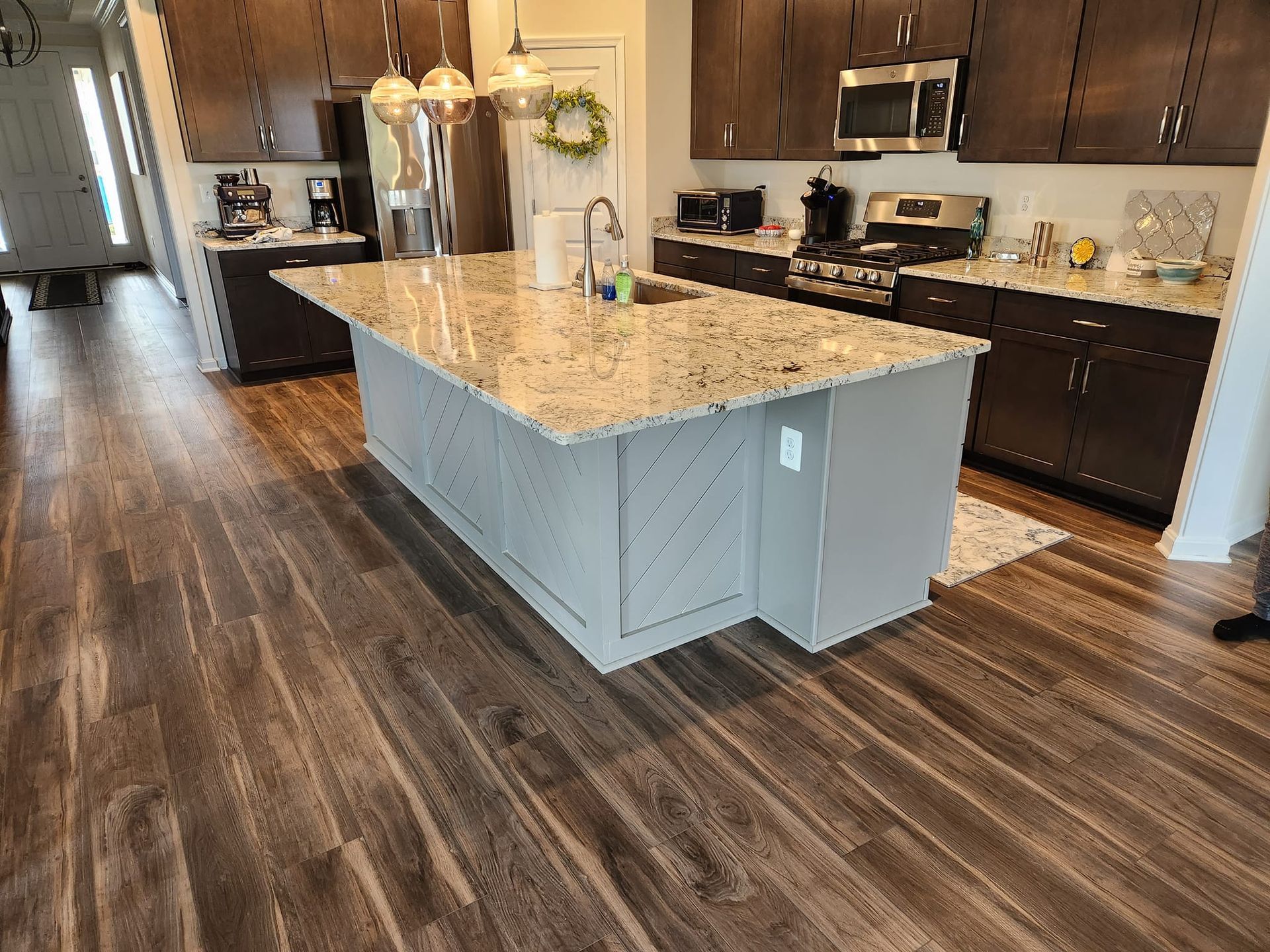 a kitchen with a large island and granite counter tops