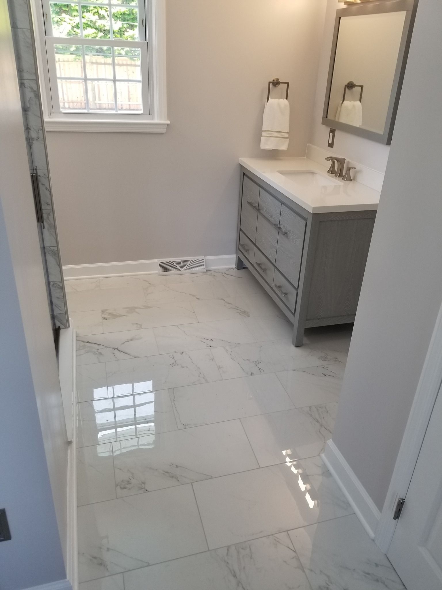 a bathroom with a sink , mirror and dresser