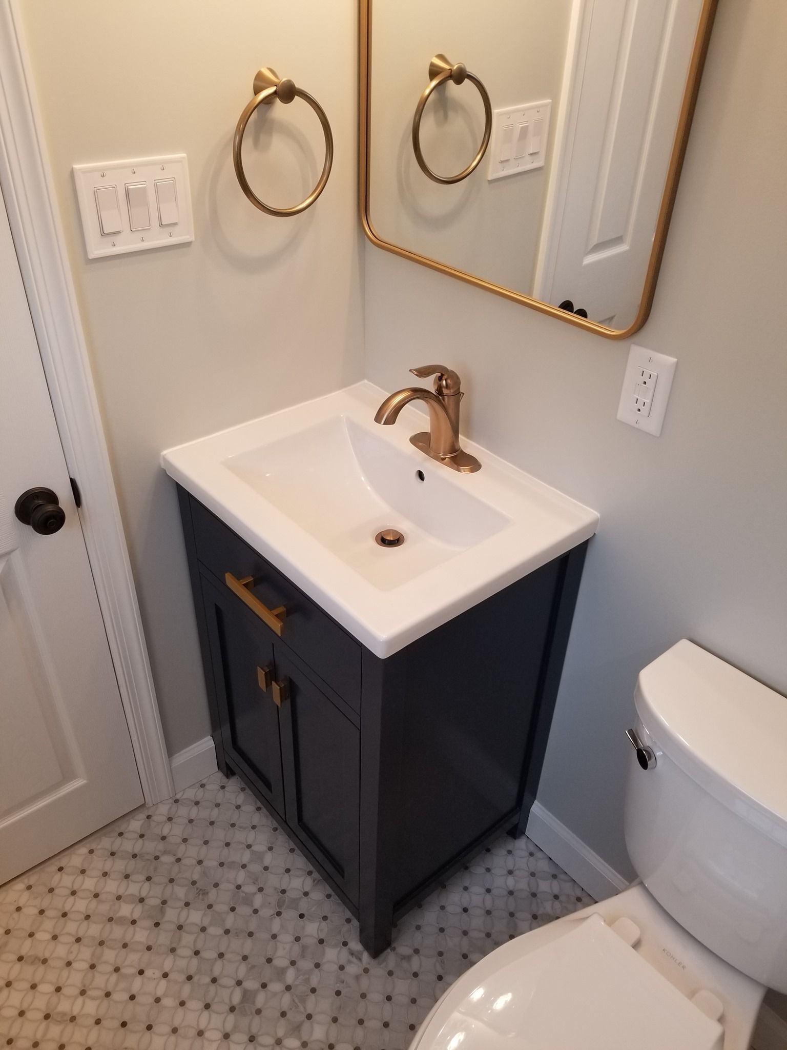 a bathroom with a sink , toilet and mirror