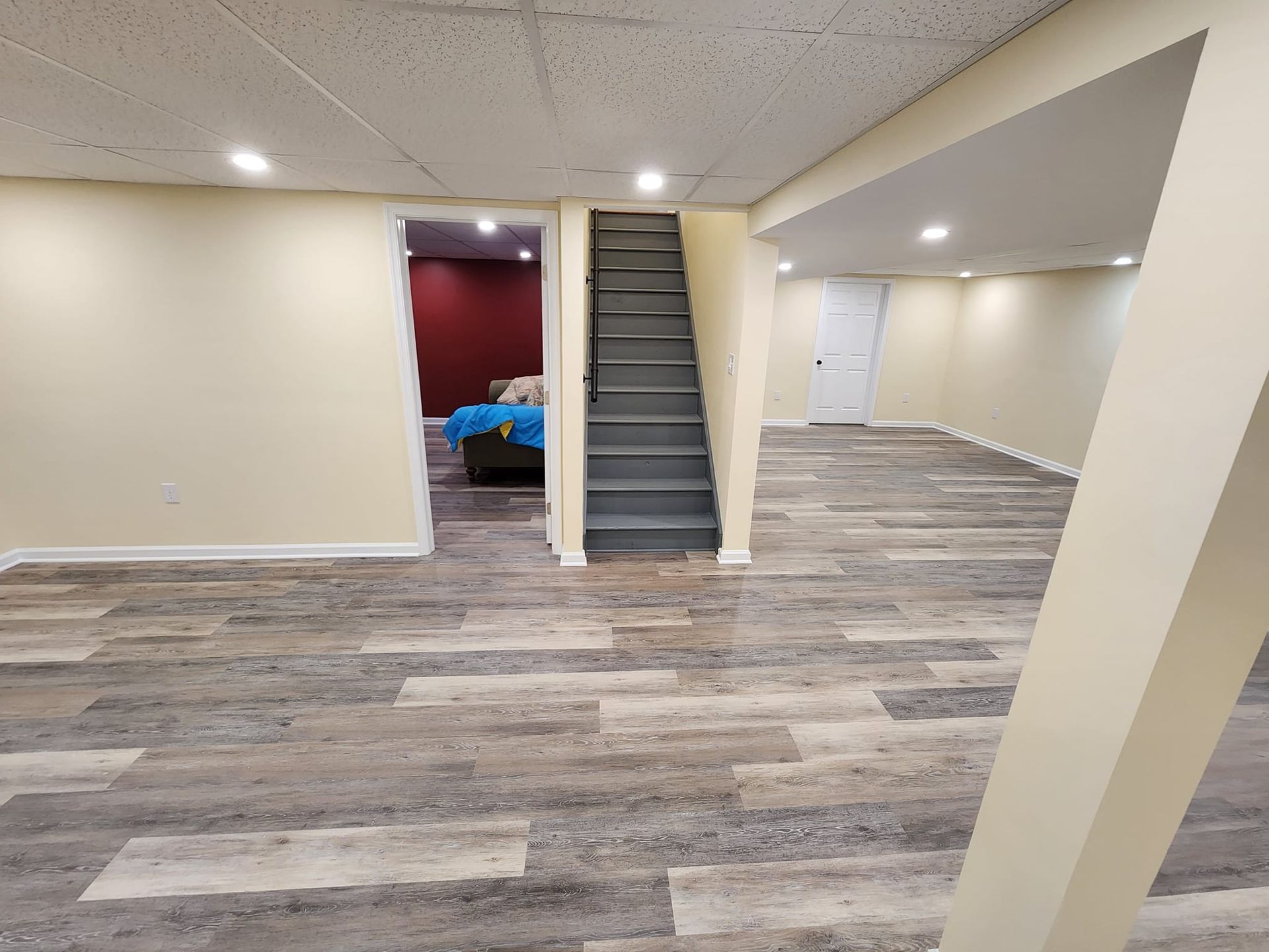 an empty room with hardwood floors and green walls