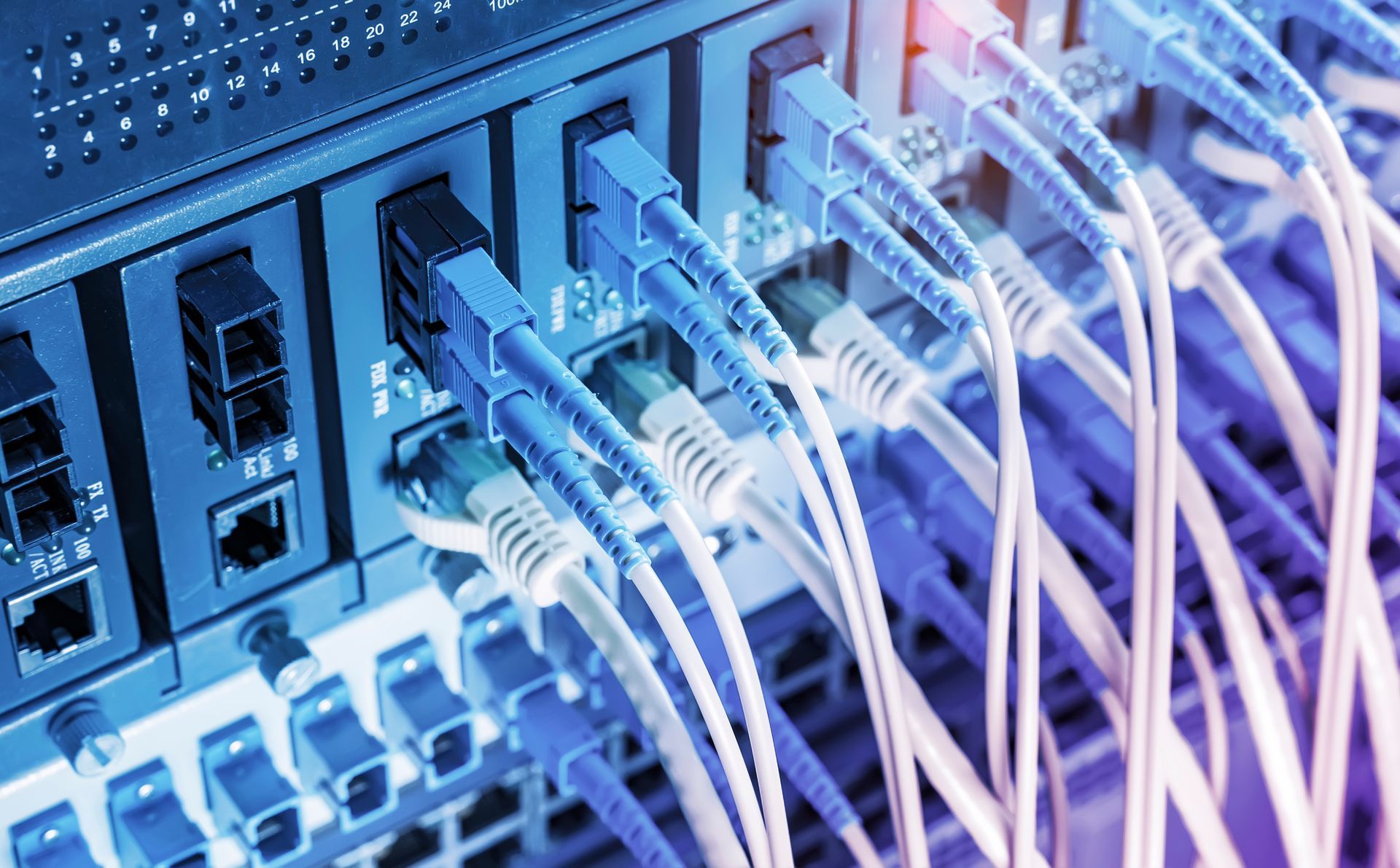 A bunch of cables are connected to a server in a data center.