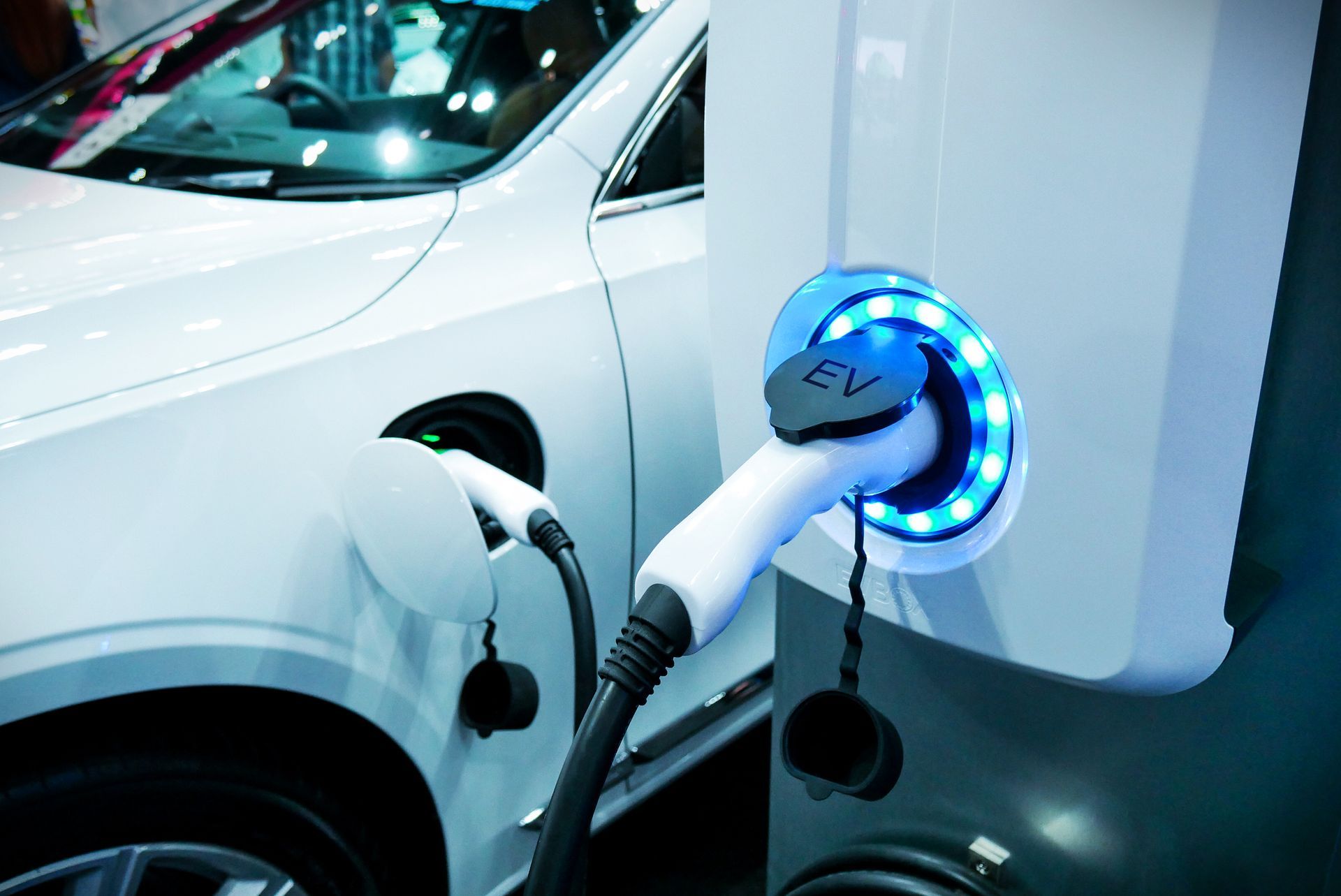 An electric car is being charged at a charging station.