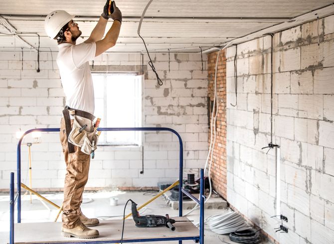 A person is changing a light bulb in a ceiling light.