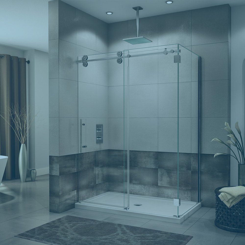 Modern bathroom with glass shower enclosure, gray tiles, and decorative plants.