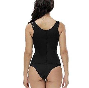 The back of a woman wearing a black swimsuit and a black waist trainer.
