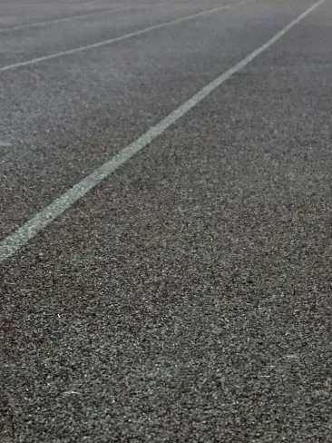 A close up of a road with a white line on it.