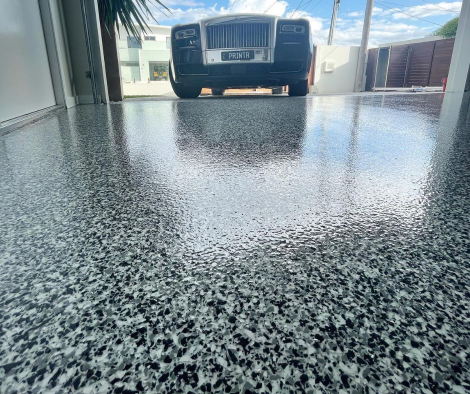 Sleek, durable garage epoxy floor installed by Coulson’s Concrete Finishes