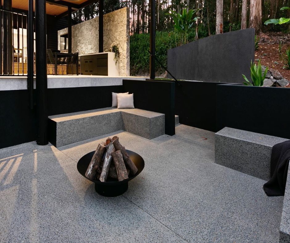 Modern concrete finish for an outdoor patio with a fire pit.