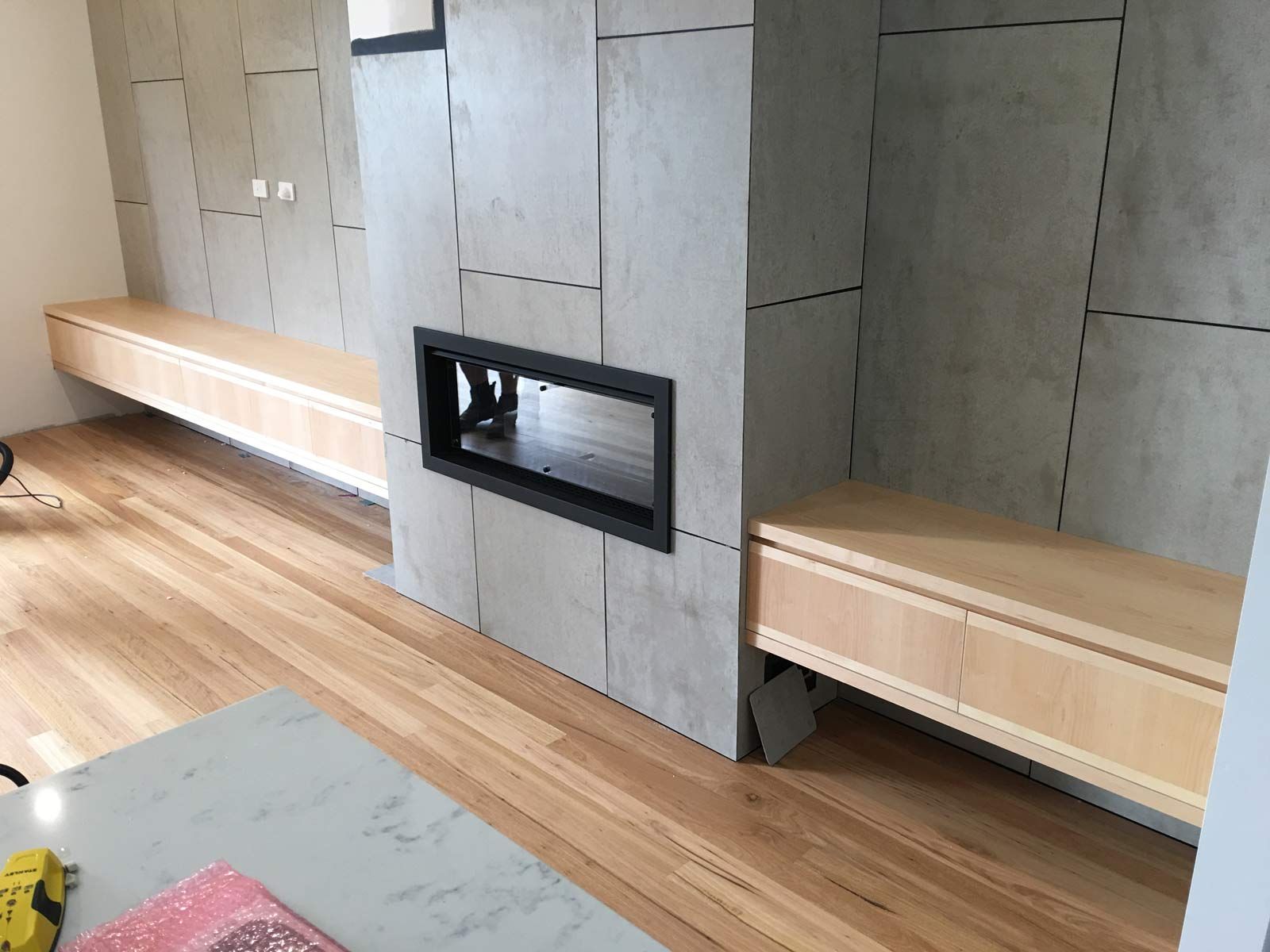 Modern Living Room With Fireplace and Floating Wooden Cabinets on Hardwood Floor — Norrland in Warners Bay, NSW
