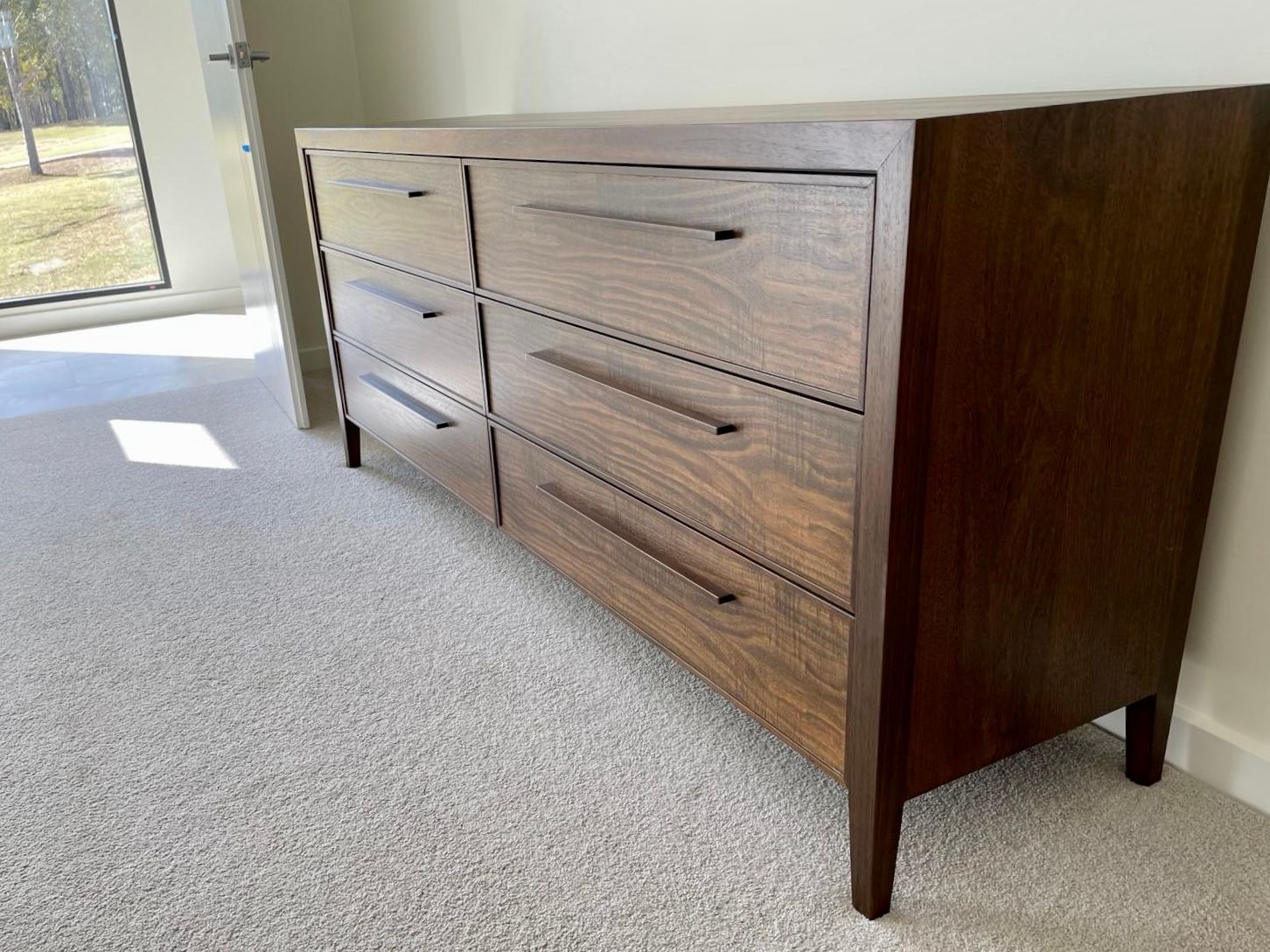 A dark wood dresser with six drawers and sleek, thin handles — Norrland in Warners Bay, NSW