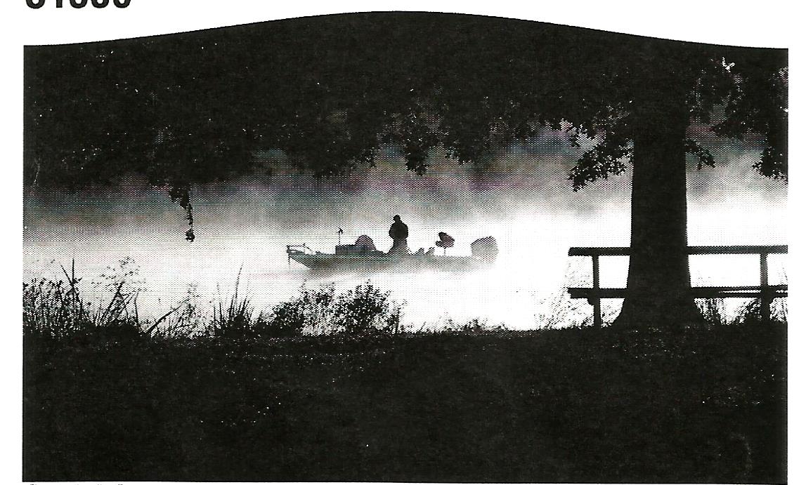 a black and white photo of a person in a kayak on a lake