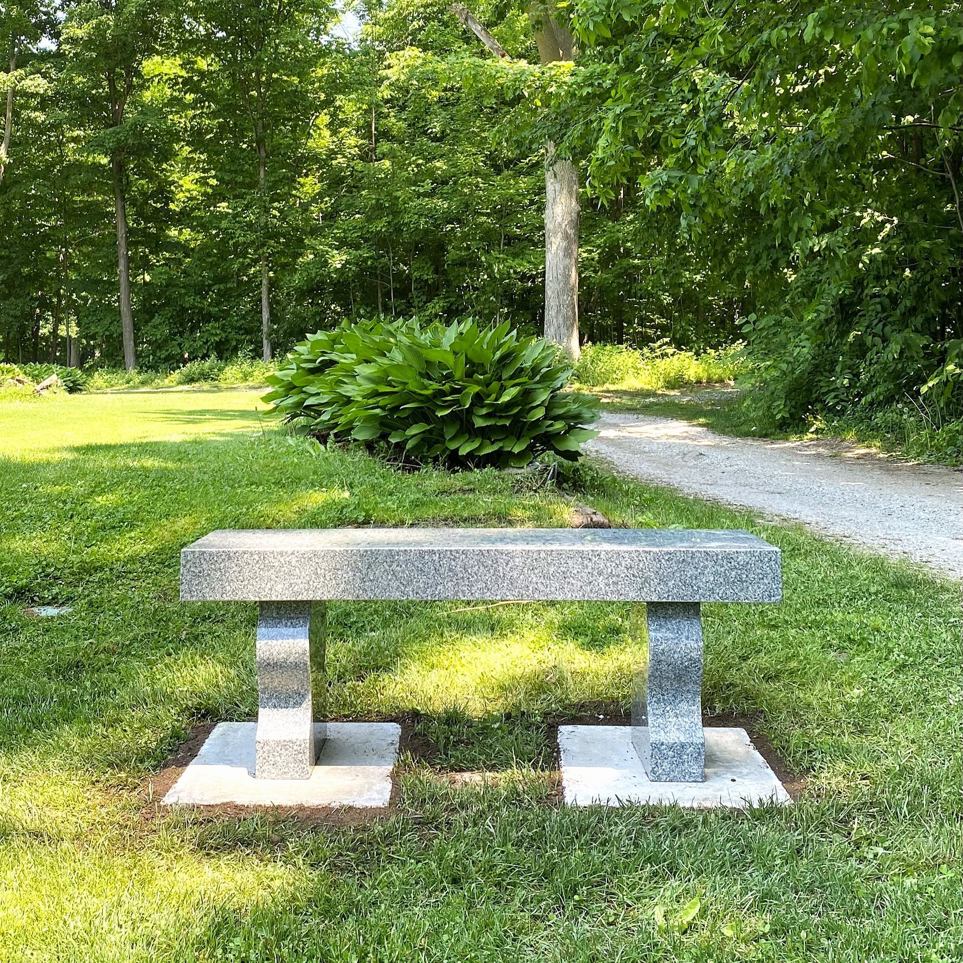 Custom granite bench installed on pavers by Champlain Monuments.