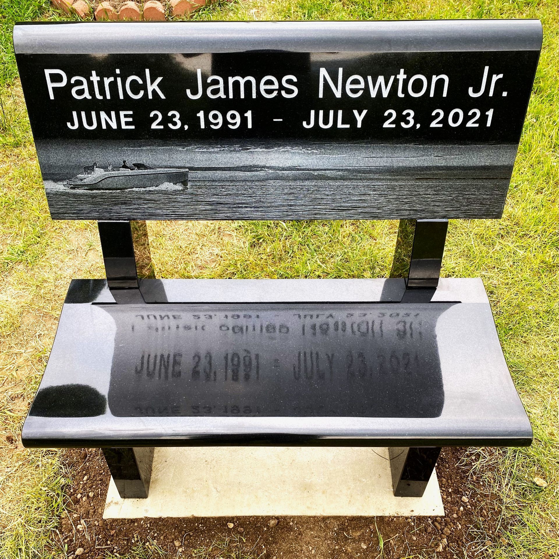 Black granite park bench installed by Champlain Monuments.