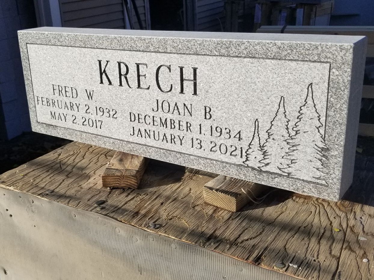a gravestone is sitting on top of a wooden table .