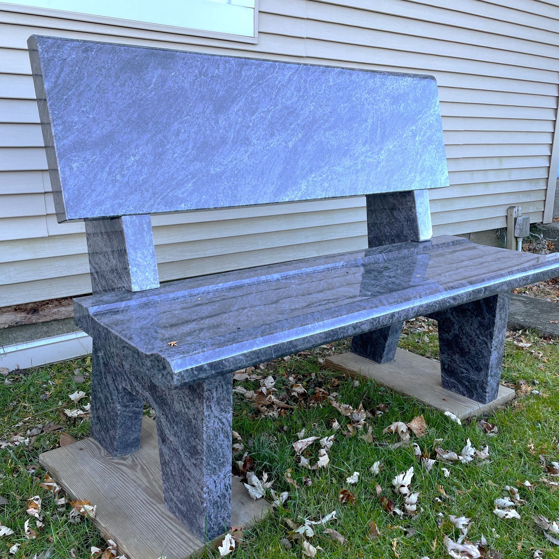A Bahama blue park style bench installed by Champlain Monuments.