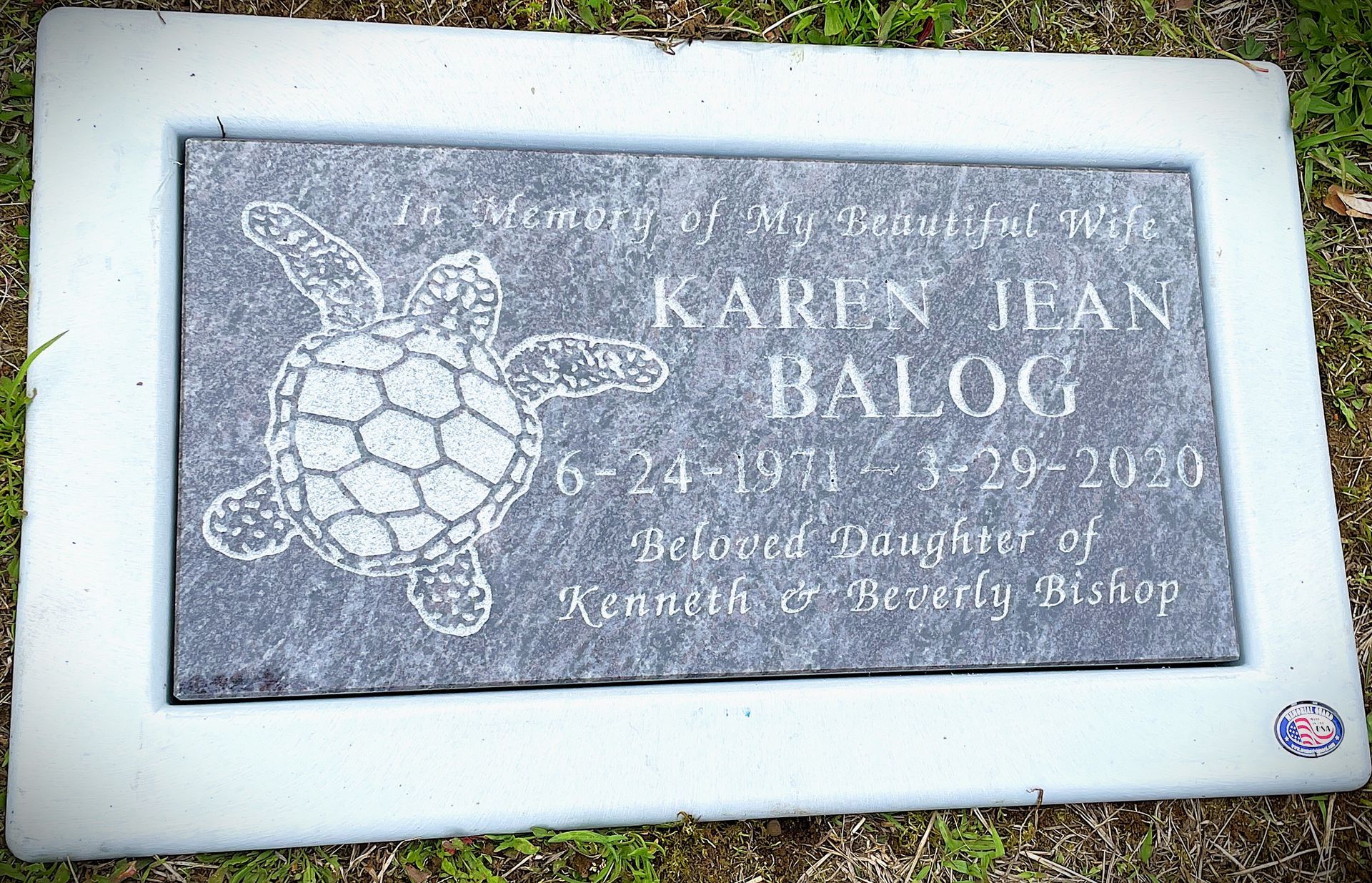 Bahama Blue granite grass marker installed with a marker sleeve.