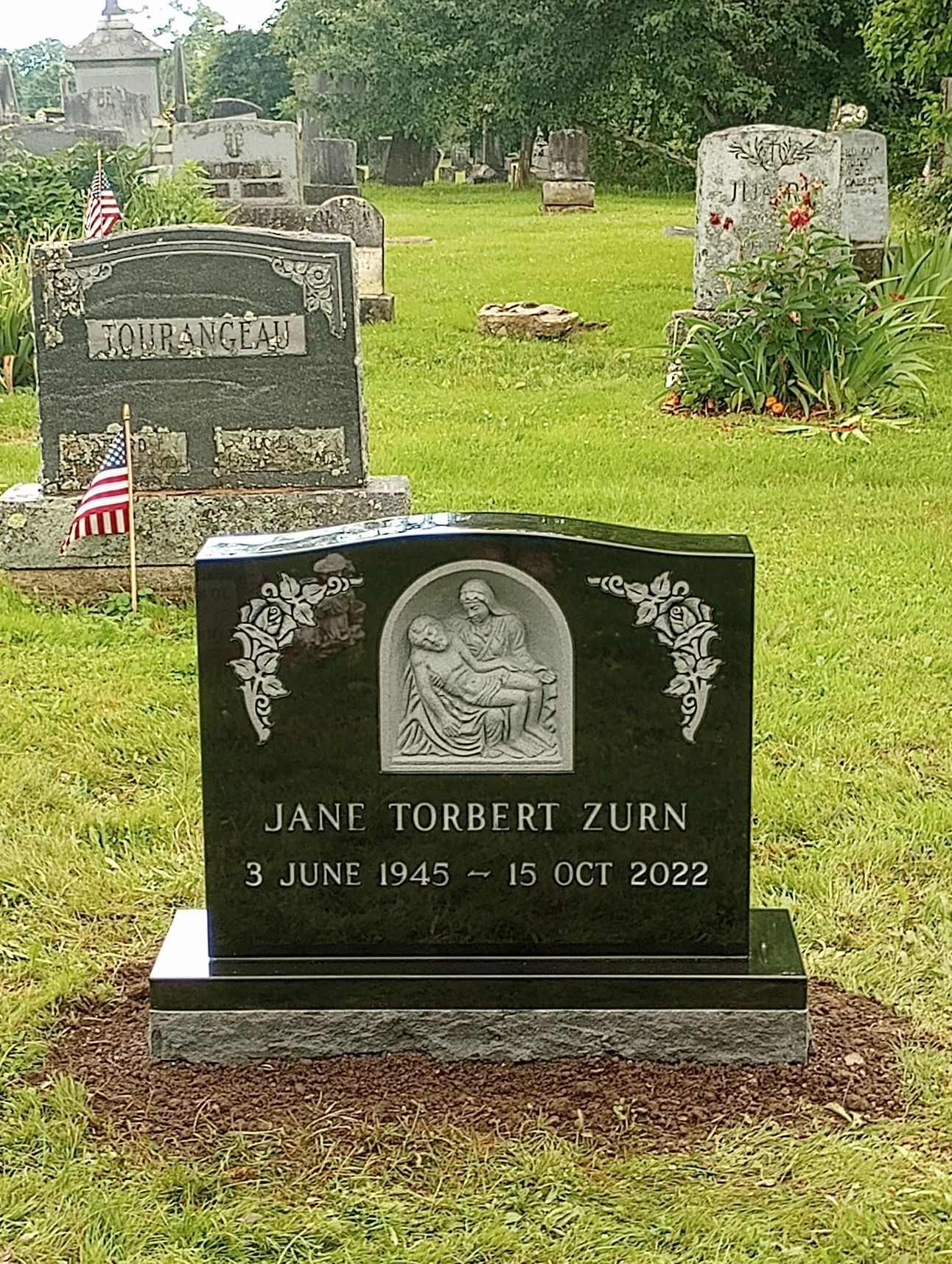 A carved design on black granite by Champlain Monuments.