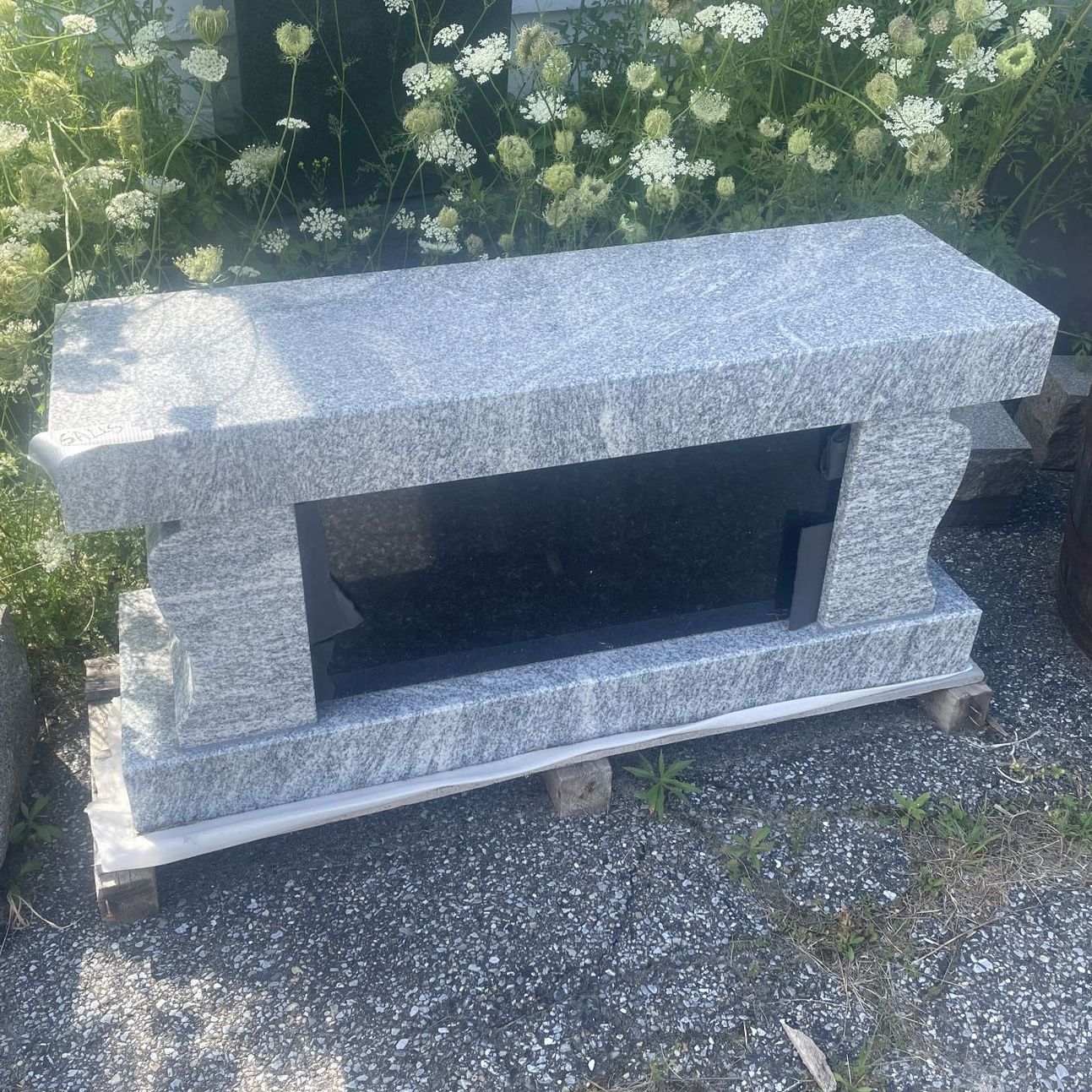 a cremation bench with a black panel
