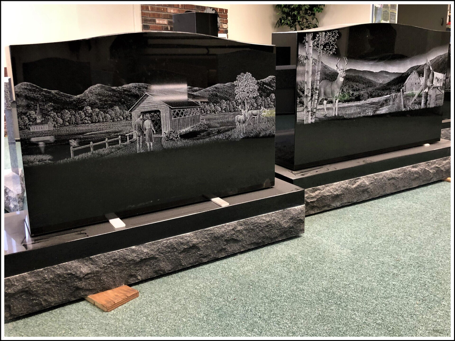 two black gravestones with etchings.