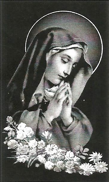 a black and white photo of a woman praying with flowers in the background