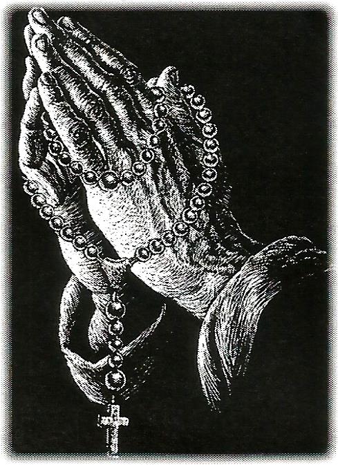 a person is praying with a rosary in their hands