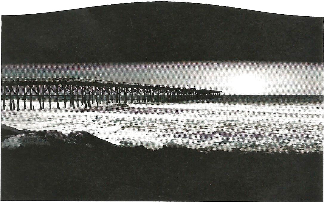 a black and white photo of a pier overlooking a body of water