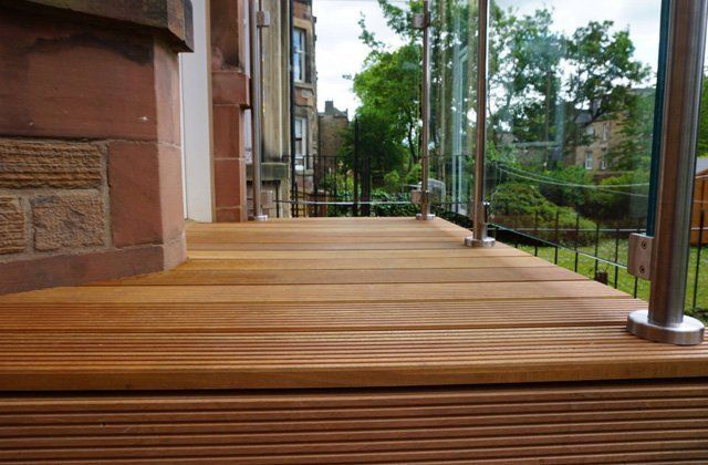 Solid Balau Decking topped with Frameless stainless steel and Glass balustrade for a touch of sophistication in the garden example 3