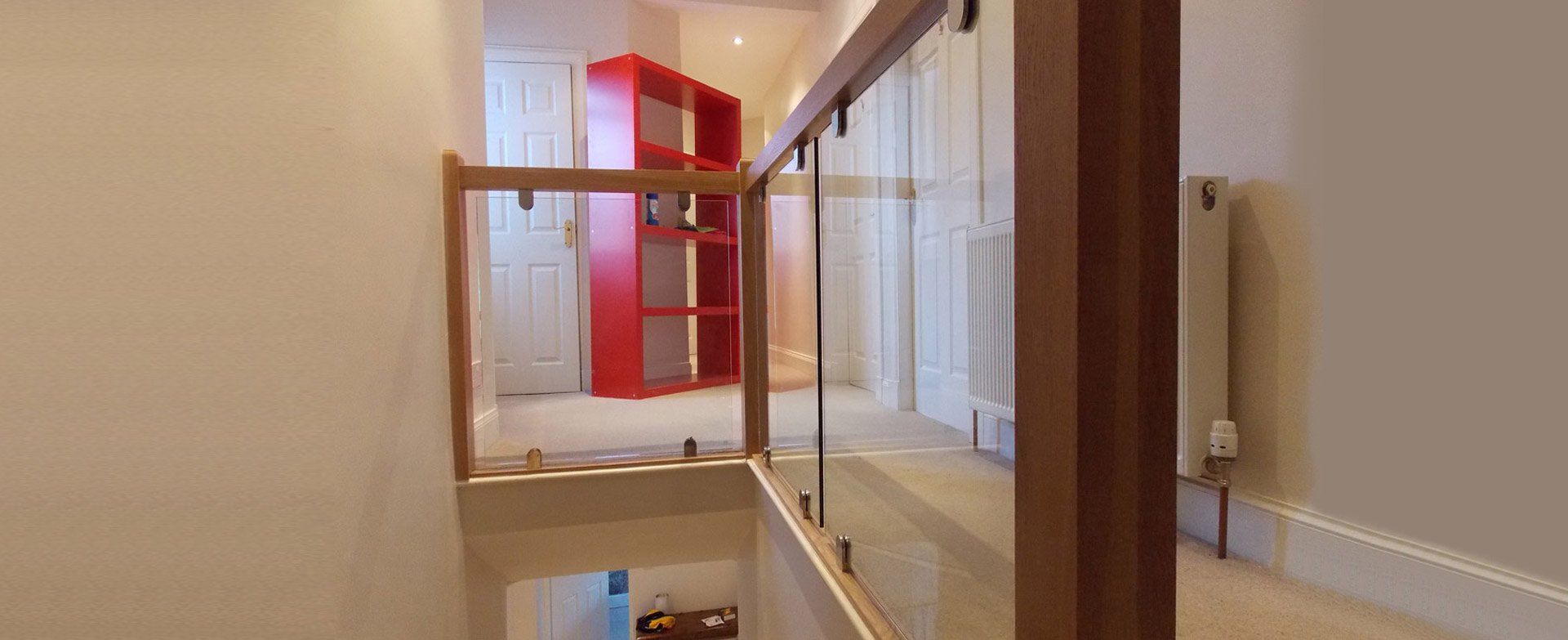 Oak and glass balustrade and oak handrail mounted on chrome brackets example 4