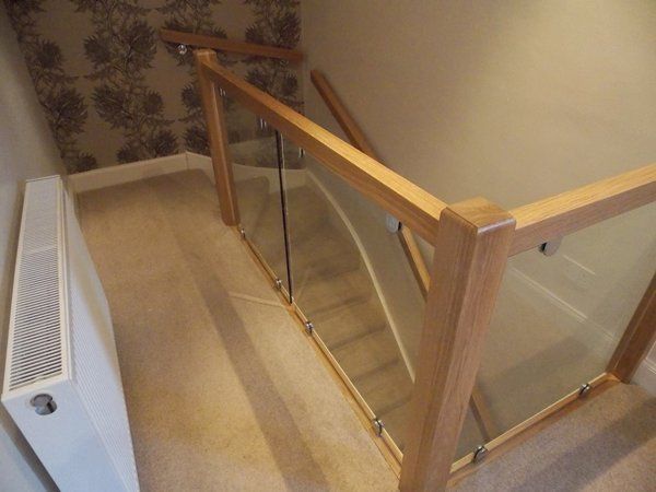 Oak and glass balustrade and oak handrail mounted on chrome brackets example 2