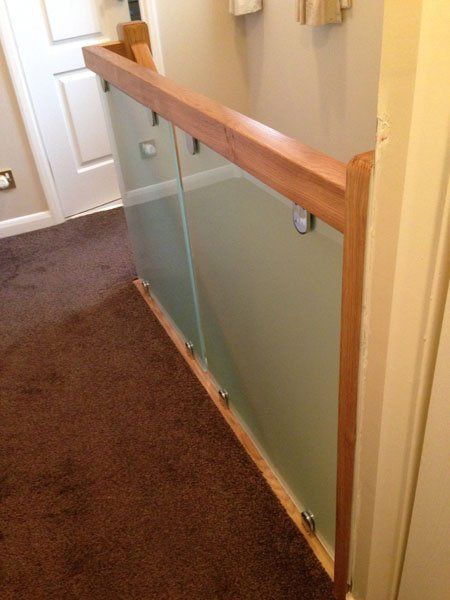 Oak balustrade finished in clear varnish with sand blast effect glass example 1