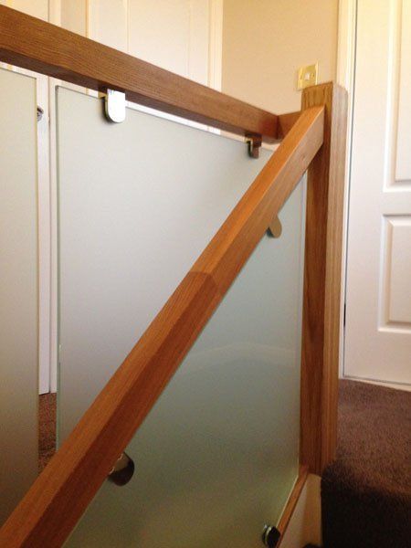 Oak balustrade finished in clear varnish with sand blast effect glass example 1