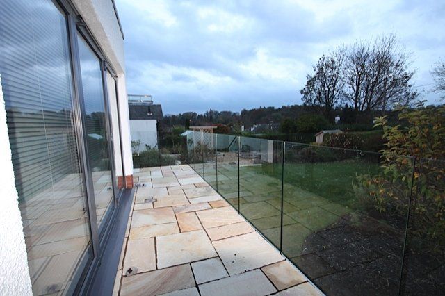 Glass bolted directly to the face of the new decking