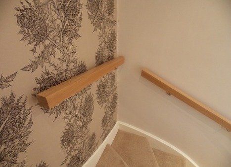 Oak and glass balustrade and oak handrail mounted on chrome brackets example 3