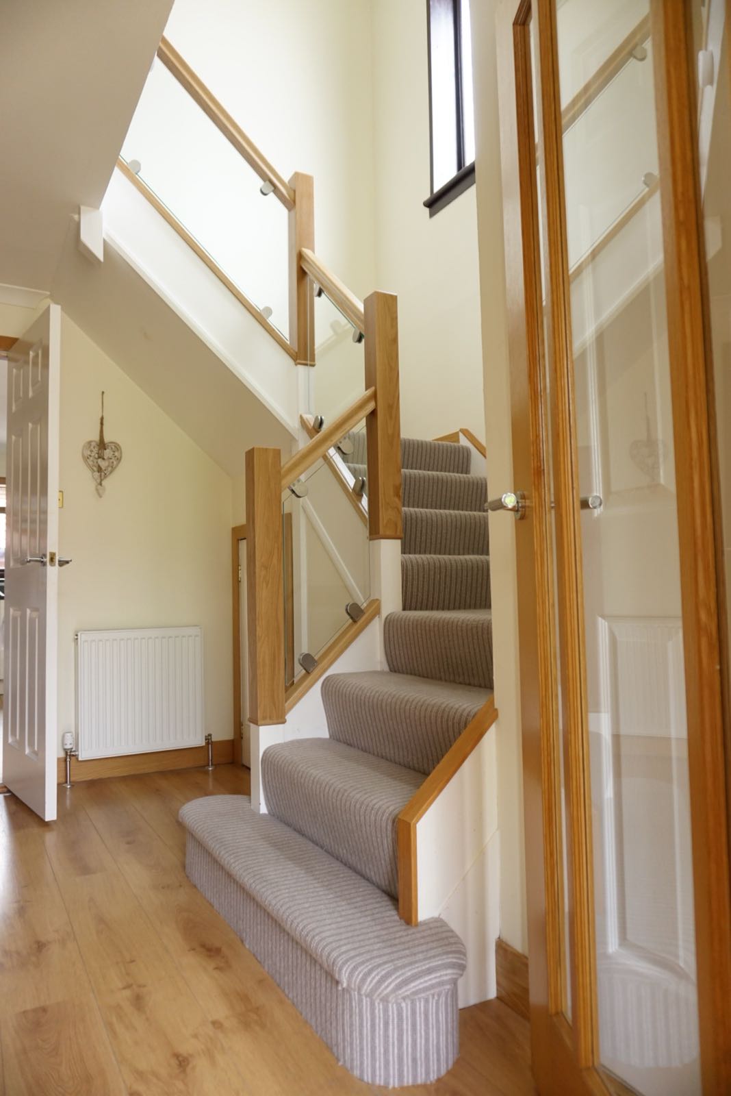 Dated staircase brought bang up to date with oak and polished glass example 1