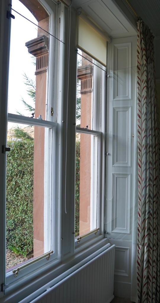 Hinged frameless secondary window