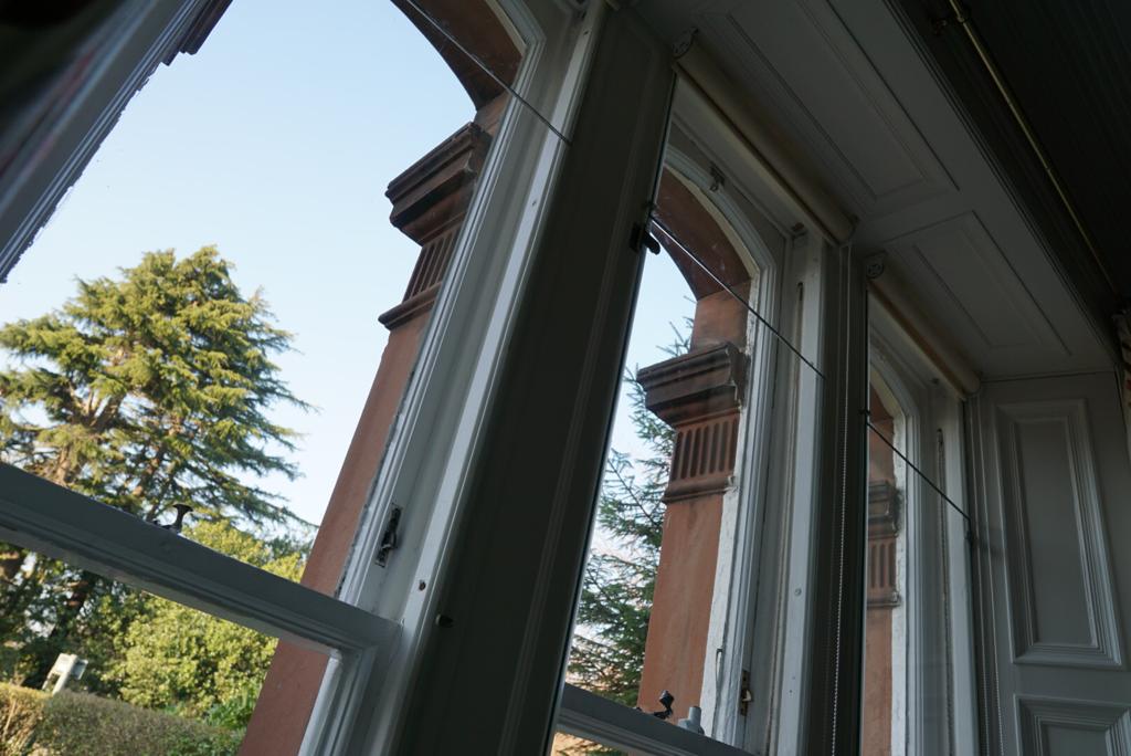 Hinged frameless secondary window