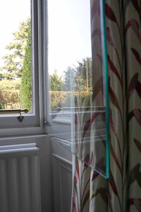 Hinged frameless secondary window