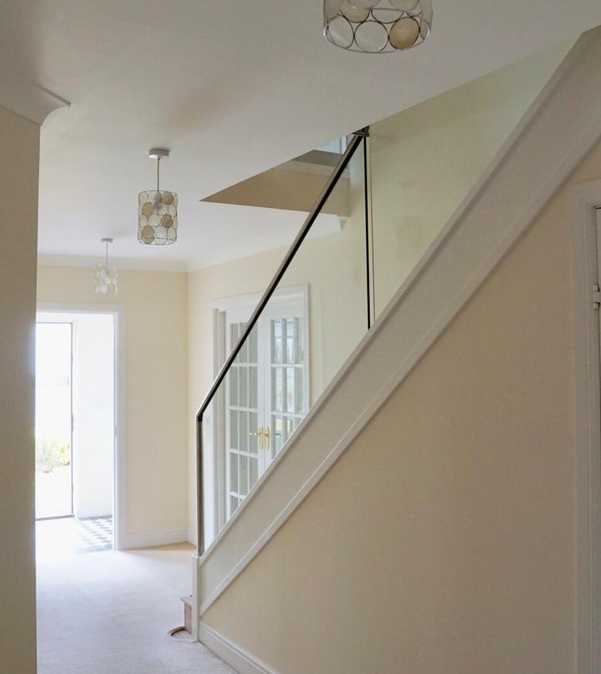 New glass balustrade with a bottom glazing channel and a stainless steel slotted handrail example 9