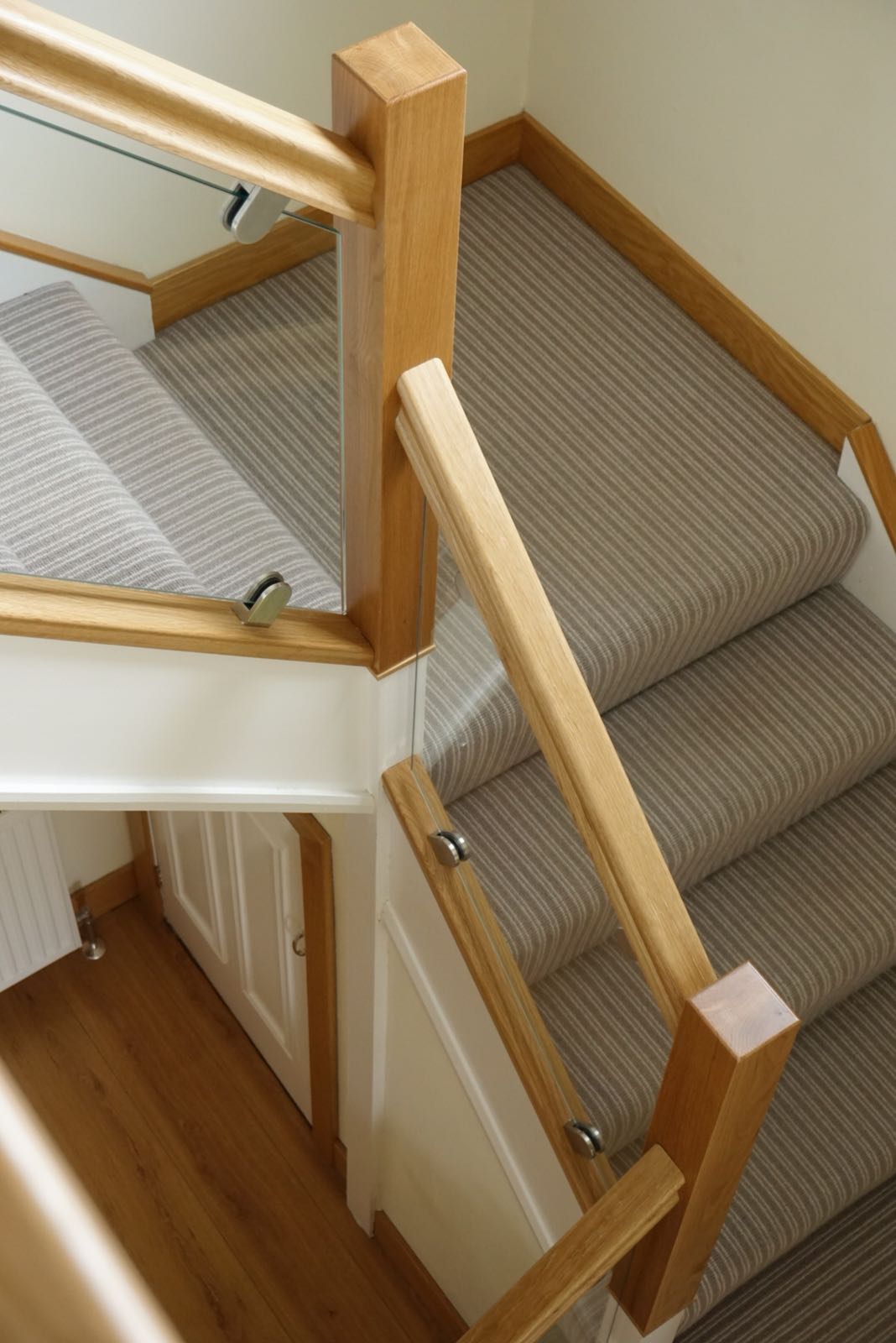 Dated staircase brought bang up to date with oak and polished glass example 2